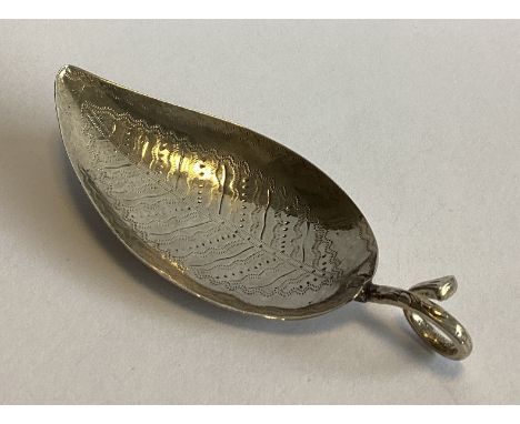 A Georgian silver leaf-shaped caddy spoon with bright-cut bowl. By EM. Approx. 10 grams.