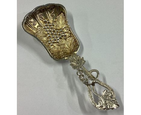 A heavy cast silver caddy spoon with vine decoration in the Victorian style. Birmingham 1978. Approx. 28 grams.
