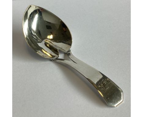 A plain Georgian silver caddy spoon of tapering form. London. By JS. Approx. 15 grams.