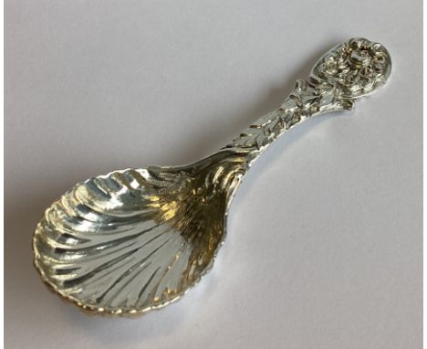 A heavy cast silver caddy spoon profusely decorated with flowers and leaves. Sheffield. By TB&S. Approx. 50 grams.