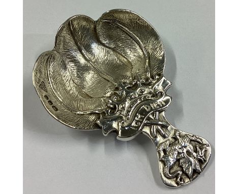 A heavy commemorative cast silver caddy spoon of textured form. London 1968. By Garrard & Co. Approx. 37 grams.