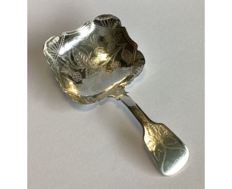 An attractive silver fiddle pattern caddy spoon with floral decoration. Birmingham 1942. By JC. Approx. 11 grams.