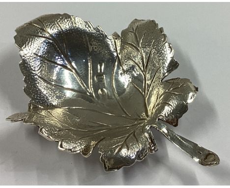 A large Continental silver caddy spoon in the form of a leaf with textured body. Approx. 24 grams.