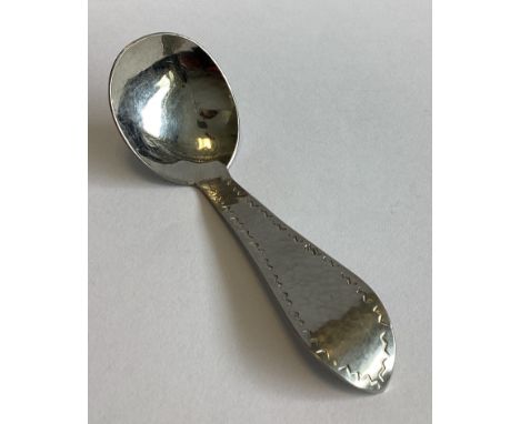 KESWICK SCHOOL OF ART: A stylish silver plated caddy spoon of textured form. Approx. 16 grams.