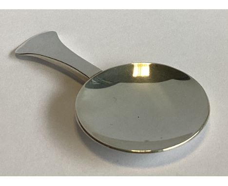A large plain silver caddy spoon. London. By PJ Ltd. Approx. 21 grams.