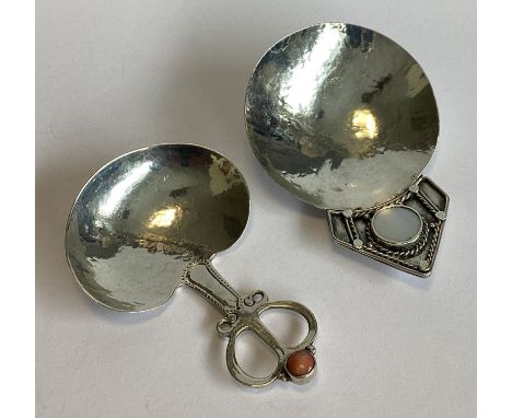 A good large Continental silver and MOP caddy spoon together with a coral example. Apparently unmarked. Approx. 36 grams.