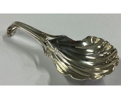A good Georgian silver caddy spoon of fluted design with scroll back. London. By WE. Approx. 10 grams.