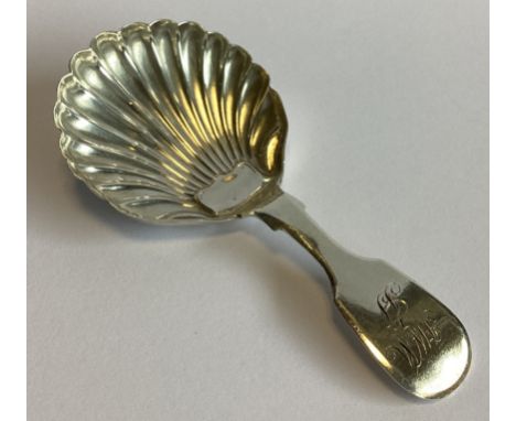 NEWCASTLE: A Georgian silver caddy spoon with fluted bowl. By CG. Approx. 14 grams.