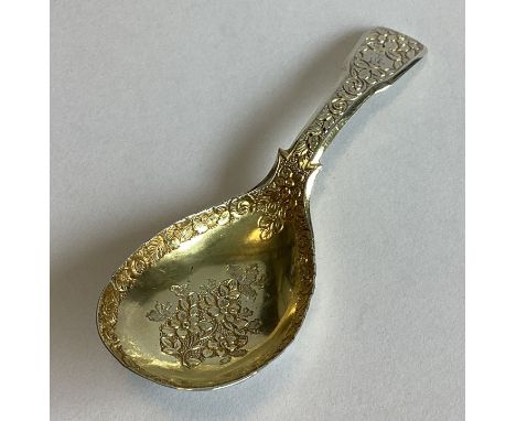 A good quality silver gilt caddy spoon profusely decorated with flowers and leaves. London 1824. By TE. Approx. 17 grams.