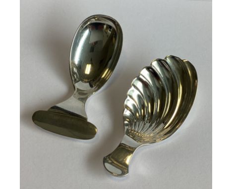 A silver caddy spoon with fluted bowl in the Georgian style. London. By DF. Together with another silver caddy spoon. Approx.