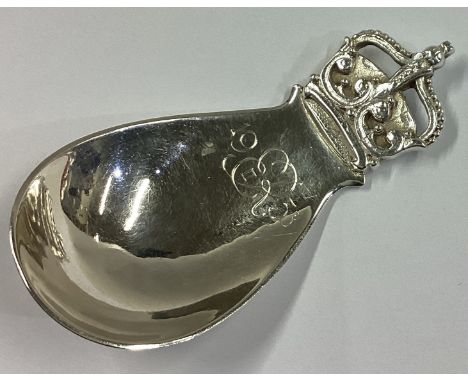 R E STONE: A good heavy cast silver caddy spoon with crown terminal. London 1953. Approx. 25 grams.