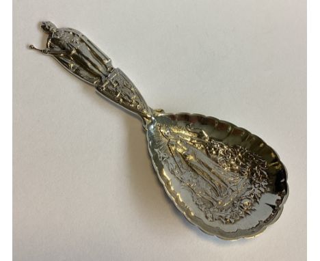EDINBURGH: A large commemorative silver caddy spoon with chased decoration. By JMT. Approx. 34 grams.