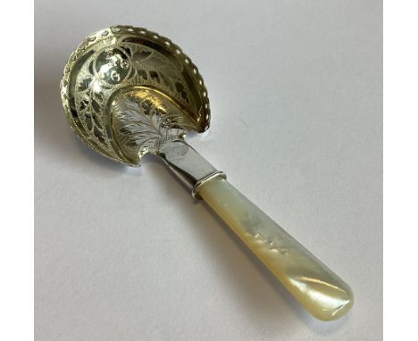 A fine quality silver caddy spoon with bright-cut decoration to MOP handle. Birmingham 1817. By IB. Approx. 11 grams.