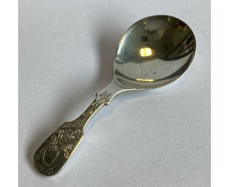 A heavy silver fiddle pattern caddy spoon with bright-cut decoration. Sheffield 1952. By FH. Approx. 19 grams.