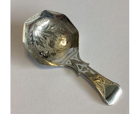 A shaped silver caddy spoon attractively decorated with flowers and leaves. Birmingham 1820. By L&C. Approx. 7 grams.