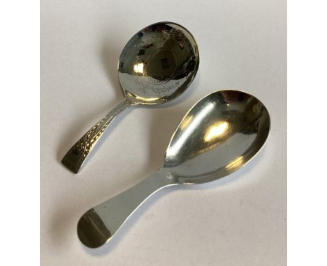 A good Georgian silver caddy spoon with bright-cut decoration. London. By JW. Together with another similar example. Approx. 