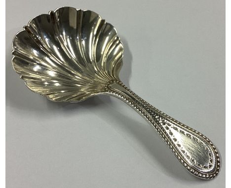A good Edwardian silver bead edge caddy spoon with fluted bowl. Sheffield 1938. By RM&EH. Approx. 15 grams.