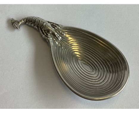 A heavy Continental cast silver caddy spoon mounted with a lobster. Approx. 31 grams.