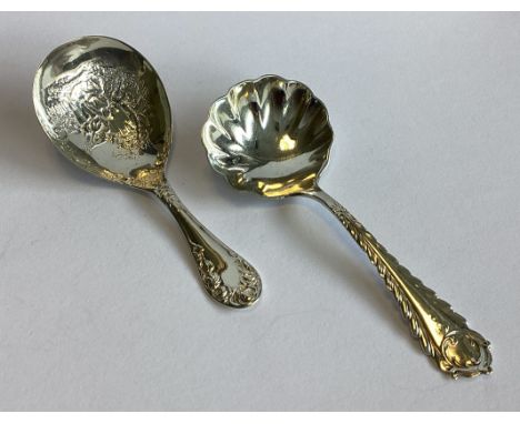 A chased silver caddy spoon. Birmingham. By L&S. Together with another silver caddy spoon. Various dates and makers. Approx. 