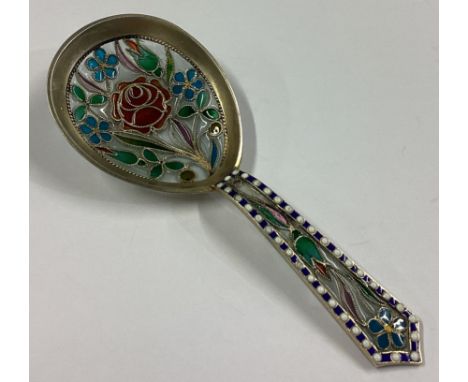 An attractive silver gilt plique-à-jour caddy spoon decorated in bright colours. Approx. 13 grams.