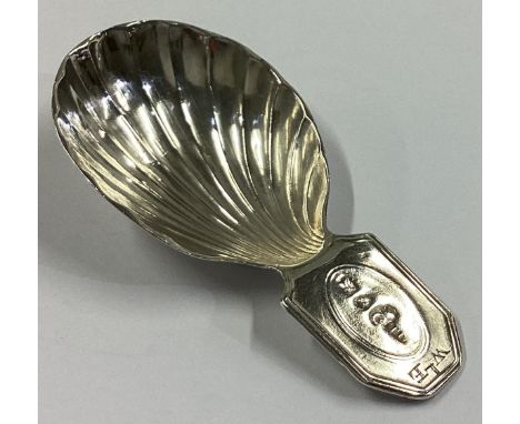 A Georgian silver caddy spoon of fluted form with rectangular thumbpiece. Sheffield. By TL. Approx. 8 grams.