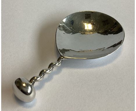 A E JONES: An unusual silver caddy spoon with twisted stem. Birmingham 1924. Approx. 16 grams.