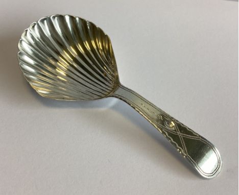 NEWCASTLE: A Georgian silver caddy spoon with bright-cut decoration to fluted bowl. By CR. Approx. 8 grams.