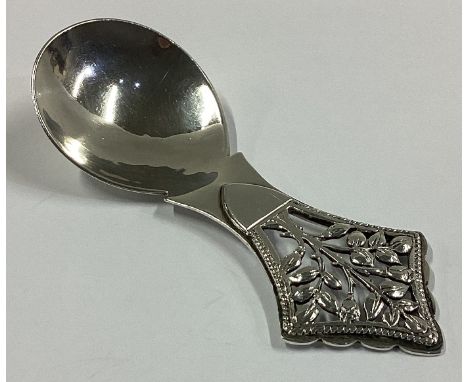 A fine quality textured silver caddy spoon depicting a tree. London 1946. By PCC. Approx. 25 grams.
