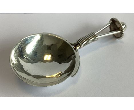 A E JONES: An unusual circular silver caddy spoon with spiral handle. Birmingham 1942. Approx. 23 grams.