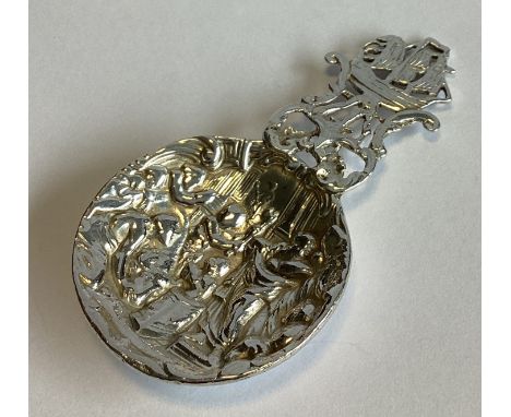 A heavy cast silver caddy spoon depicting a sailing boat with pierced decoration. London. By AB. Approx. 40 grams.