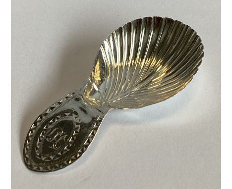 A good Georgian silver caddy spoon of fluted design with bright-cut decoration. By NS. Approx. 6 grams.