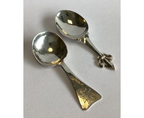 A Modernistic silver caddy spoon. London. By Goldsmiths & Silversmiths. Together with another silver caddy spoon. Approx. 32 