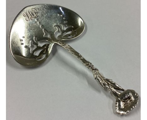 TIFFANY & CO: A stylish silver caddy spoon with heart-shaped pierced bowl to flower terminal. Approx. 13 grams.