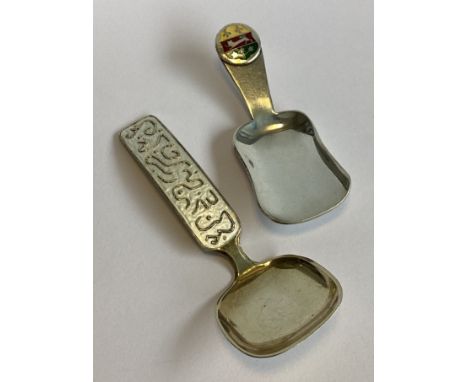 A Norwegian silver and enamelled caddy spoon together with another similar example. Approx. 41 grams.