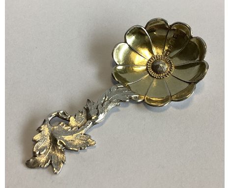 A fine silver and silver gilt caddy spoon in the form of a flower with scroll handle. Birmingham 1852. By Hilliard & Thomason