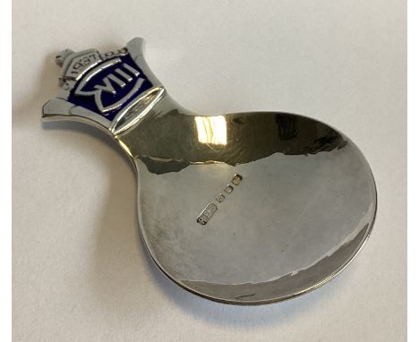 A stylish commemorative silver and enamelled caddy spoon of circular form. London 1936. By R E Stone. Approx. 26 grams.