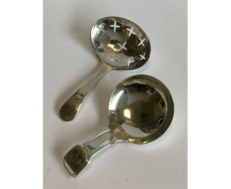 A pierced Georgian silver caddy spoon with bright-cut decoration together with another similar example. Approx. 15 grams.