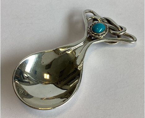 A stylish silver caddy spoon with weave terminal to central turquoise stone. Birmingham 2005. Approx. 41 grams.