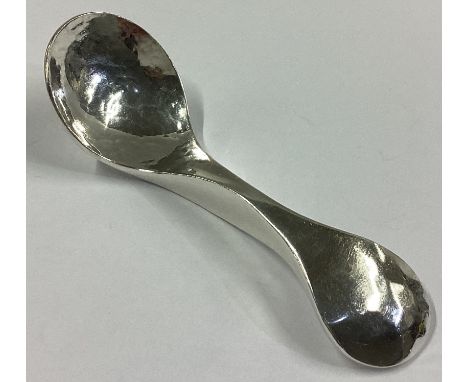 EDINBURGH: A heavy handmade textured silver caddy spoon of shaped form. 1994. By Graham Leishman Stewart. Approx. 48 grams.
