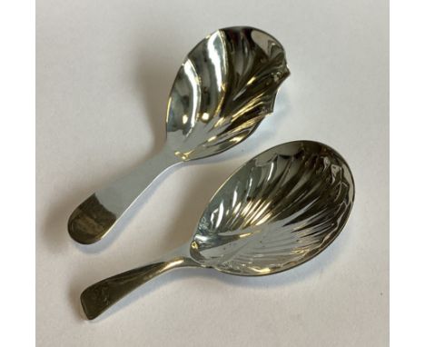 A heavy plain Georgian silver caddy spoon with fluted bowl. London. Together with another similar example. Approx. 27 grams.