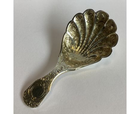 An attractively engraved silver and silver gilt caddy spoon. London 1853. By WE. Approx. 21 grams.