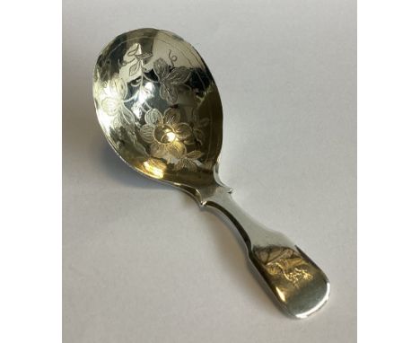 A good silver fiddle pattern caddy spoon with engraved floral decoration to bowl. Birmingham 1832. By WK. Approx. 14 grams.