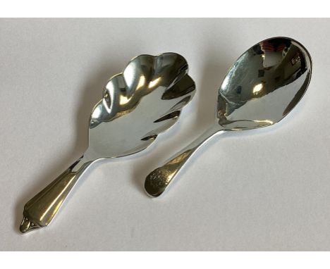 A good shaped Georgian silver caddy spoon of plain form. London. By GS&WF. Together with another similar example.  Approx. 27