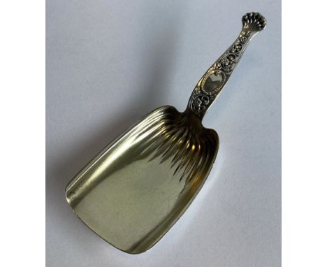 A Continental silver gilt caddy scoop with fluted decoration. Approx. 13 grams.