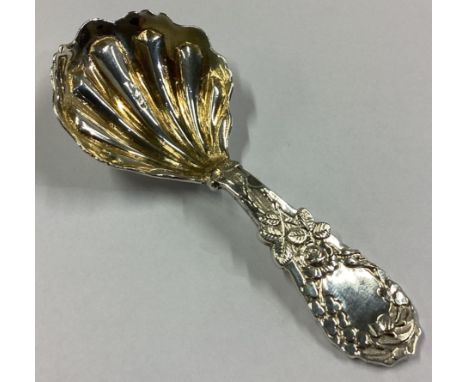 A heavy cast silver caddy spoon decorated with roses to gilt bowl. Birmingham 1886. By JW. Approx. 22 grams.