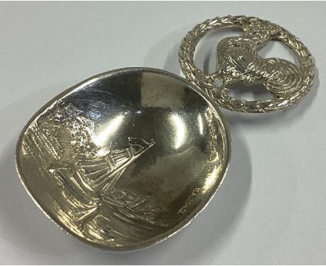 A French silver caddy spoon decorated with sailing scene bearing import marks. Approx. 21 grams.