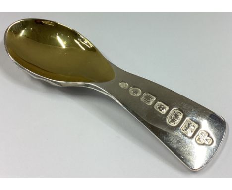 A good heavy cast silver caddy spoon with scroll decoration and gilt bowl. London 2012. By Wayne Meeten. Approx. 57 grams.