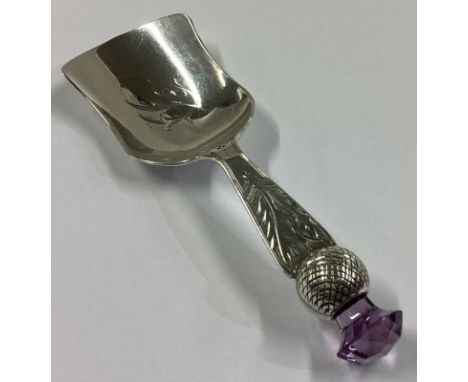 A large engraved silver caddy scoop with amethyst finial. Birmingham. By WJ. Approx. 18 grams.