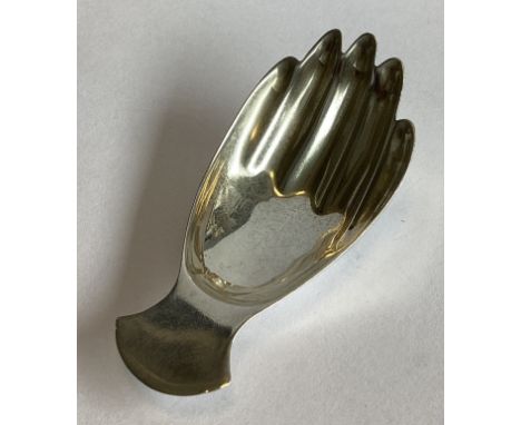 A silver caddy spoon in the form of a hand of plain form in the Georgian style. Sheffield 1971. By FH. Approx. 15 grams.
