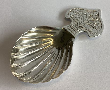 A heavy modern silver caddy spoon with chased decoration. London. By FEK. Approx. 23 grams.